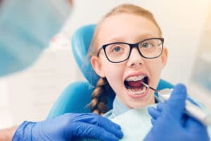 Smart little girl visiting dental professional